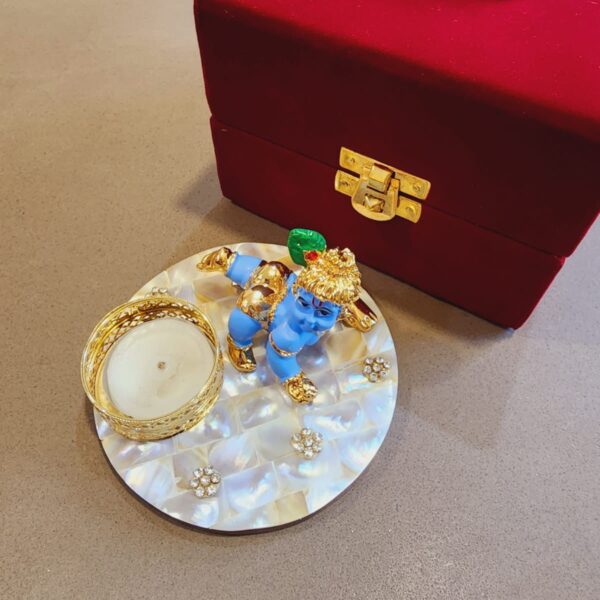 Janmashtami Special Gifting Box Celebrate the divine occasion of Janmashtami with our exquisite Laddu Gopal on Mother of pearl. This stunning piece features a beautifully crafted Laddu Gopal figurine on a vibrant Mother of Pearl, symbolizing the eternal love and blessings of Lord Krishna. - Made from high-quality Mother of pearl platter size 4 inches - Intricately crafted Laddu Gopal figurine - Janmashtami special edition - Luxurious gifting box - Perfect for gifting or personal use - Auspicious and divine gift