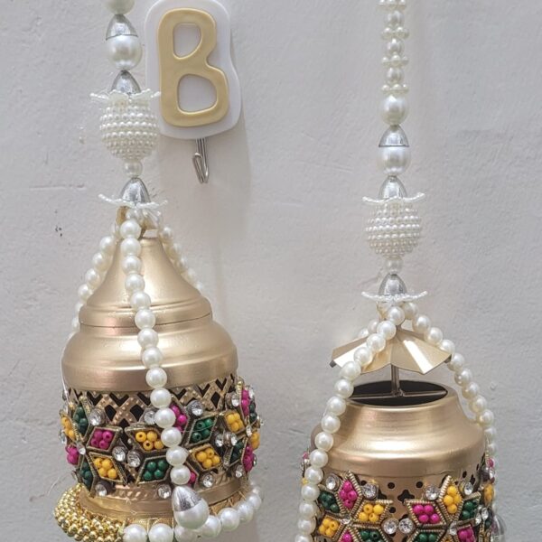 "Design is defined by light and shade, and appropriate lighting is enormously important." Full Metallic With Powder Coating And Handcrafted Work N Hangings Size:- 4 Inches (Only Lanterns) 8 Inches (With Pearl Hangings) Set Of 2 Pcs