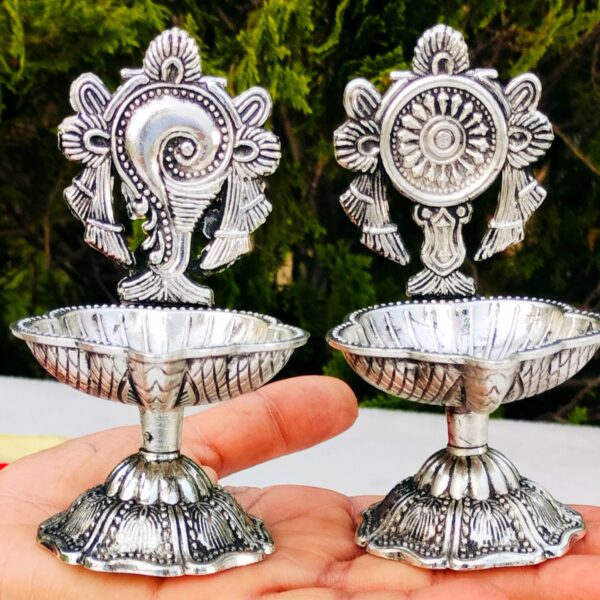 Antique German silver shankh chakra diya pair