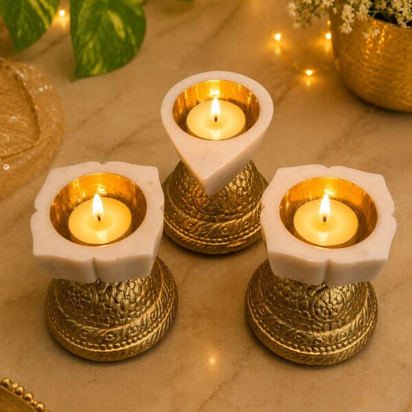 Drop shape brass katori marble diya resting on stand