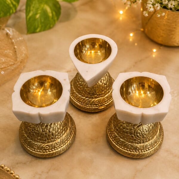 Drop shape brass katori marble diya resting on stand